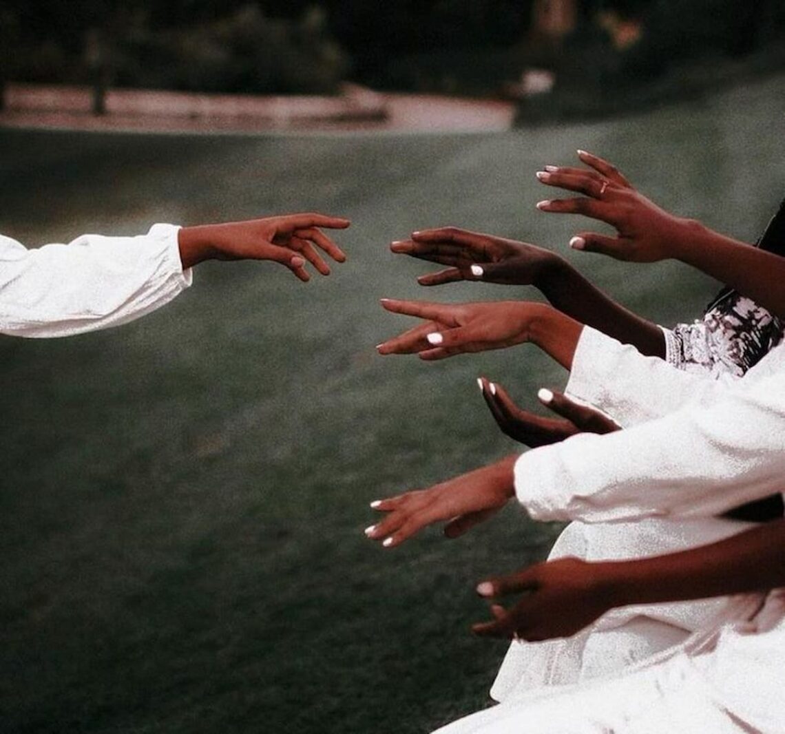 Female hands with short, neatly shaped nails painted in a smooth white color.