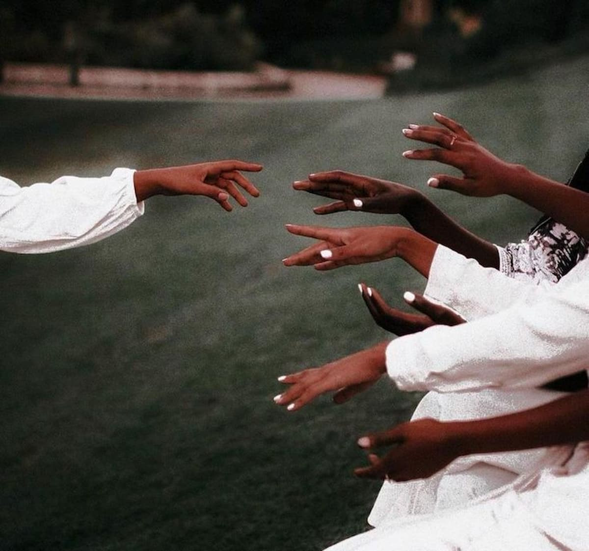 Female hands with short, neatly shaped nails painted in a smooth white color.