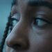 An image of a sad, black girl's face up-close, showing only her facial features