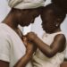 “A young African mother sits closely with her child, their foreheads gently touching as they hold hands — a tender moment of connection and quiet love