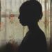 Silhouette of a young girl standing by the widow with the curtains closed.