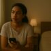 You wanted a woman sitting by a window, looking away from her phone