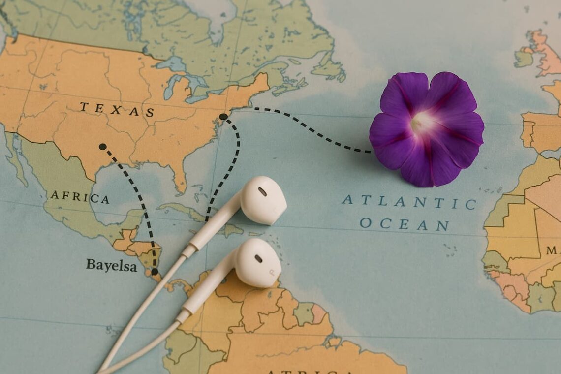 Focus on a map showing Nigeria and the U.S., with a dotted line from Bayelsa to Texas to Maine, with a pair of earbuds or notebook lies on the map, and a purple Morning Glory petal rests on the page.