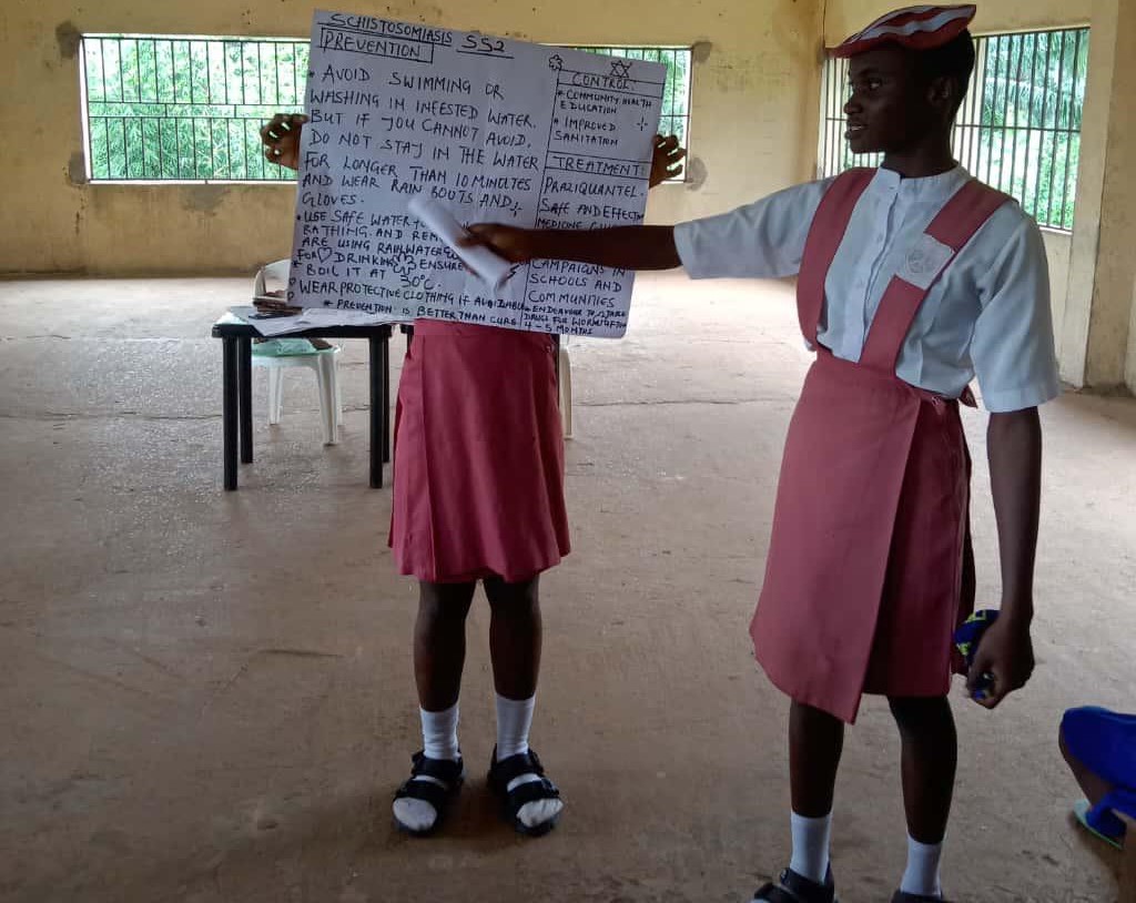 A close-up photo of Nwadiuto, our narrator, teaching her students about schistomiasis
